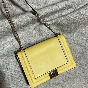 INC crossbody bag. Convertible into shouldered or clutch bag. Buttercream Yellow